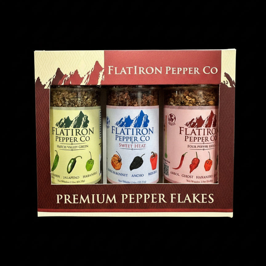Three jars of Flatiron Pepper Co. premium pepper flakes in a decorative box.